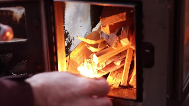 Starting a fire in a wood stove. Light a wood fire. Burn fire starter