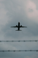 A large jet is flying through a cloudy sky