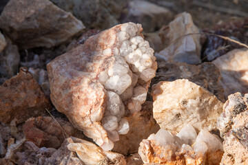 Large Quartz Stone with White and Pink Crystalline Formations in Sunlight