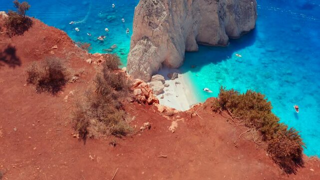 Zakynthos Island Rich Red Soil and dream beach from above. Drone top down reveal shot of cliffs of Keri in Ionian sea, Greece. White beach with big stones and crystal clear water