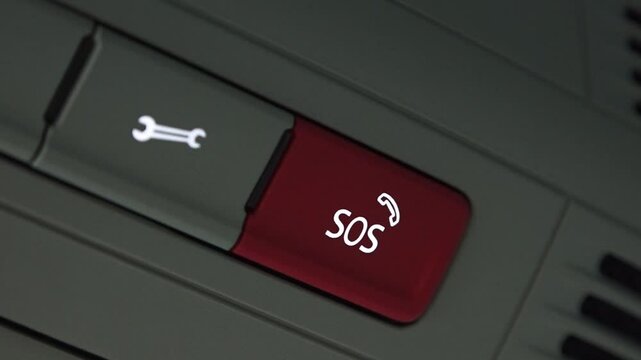 Valmiera, Latvia - November 28, 2024 - Close-up of a red SOS emergency button in a car interior, showing a sleek design and functionality for safety and assistance.
