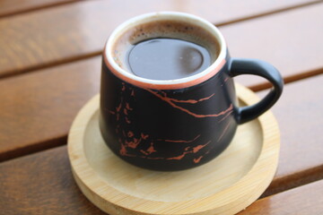 Cup of coffee on wooden table. Morning coffee