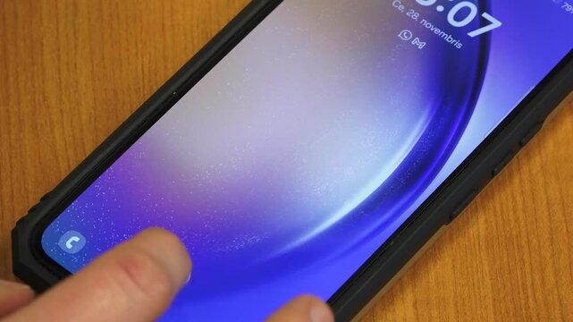 Valmiera, Latvia - November 28, 2024 - Close-up of a smartphone on a wooden surface, displaying an emergency dialer screen with a numeric keypad and medical info option.
