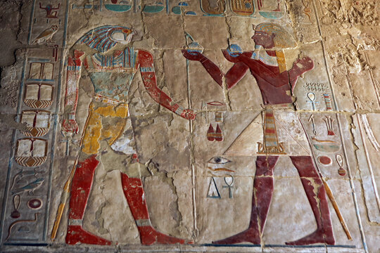 Reliefs of Sokaris (Osiris) and Pharaoh Thutmose III in Mortuary temple of Hatshepsut in Deir el-Bahari, Egypt
