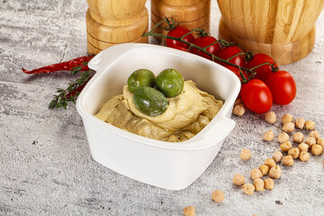 Tasty hummus with green olives