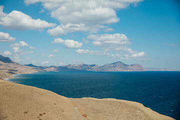 Beautiful landscape on beach, rocks and blue sky with clouds © dmitriisimakov