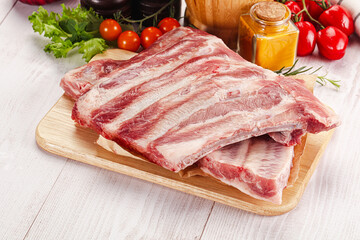 Raw pork ribs over board