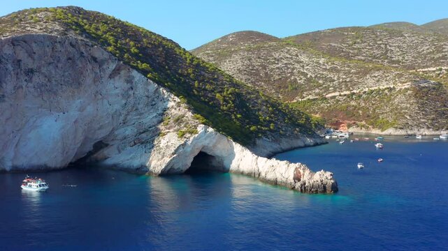 Zakynthos Greek island typical coastline with white limestone cliffs in Zante with cave or grotto Aerial view over blue ocean and green hills