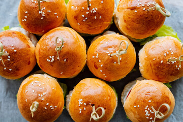 A beautiful stack of freshly baked hamburger buns sits invitingly on a table, eagerly waiting to be used for crafting delicious burgers or tasty sandwiches for everyone to enjoy