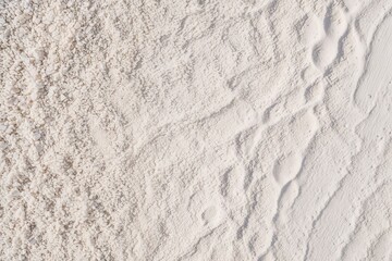 Elevated View of Bright White Surface with Scattered Fine Beach Sand Texture