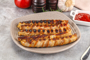 Grilled meat sausages wrapped bacon