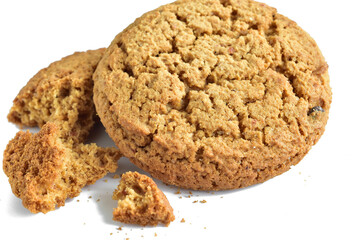 Oatmeal cookies and their crumbs lie on a white background.