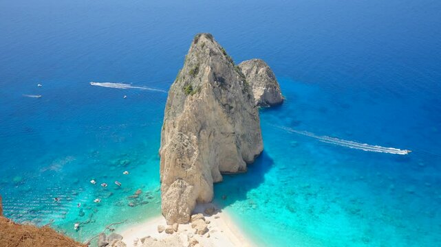 Famous Greece beach Mizithres rocks on south coast of Zakynthos Greek island. Beautiful lagoon in turquoise colour and a white boat