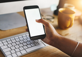 Phone, hands and woman with blank screen, computer and work from home with freelancer. Social media, app and notification at desk with online, texting and technology with internet search and mockup
