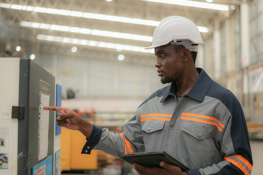 Worker using technology in an industrial setting.