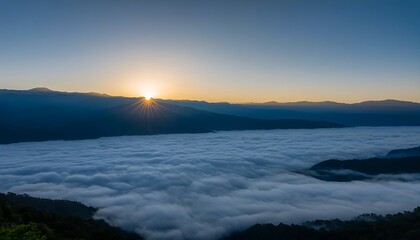 Obraz premium Mystic valley with clouds, distant mountains at dawn.