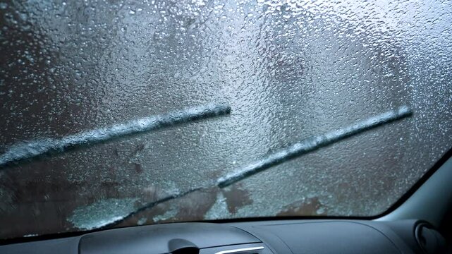 frozen car windshield, wipers remove ice
