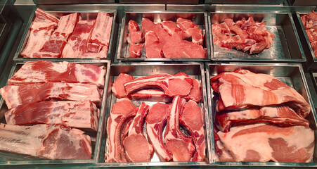 Butcher shop fridge counter with cold raw meat