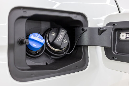 Close up Adblue Diesel exhaust fluid DEF and fuel tank cap. Tank filler neck for AdBlue and Diesel fuel close-up. Adblue diesel exhaust fluid fuel tank cap. Environmental pollution by exhaust gases.