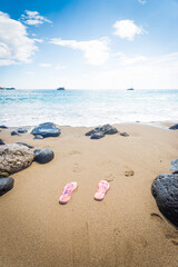 Pair of flip-flops on sandy beach near Siracusa, Sicily, Italy, Europe