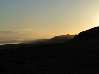 Sandy beach and walkers in the distance with back light in Balmedie - Aberdeenshire - Scotland - UK