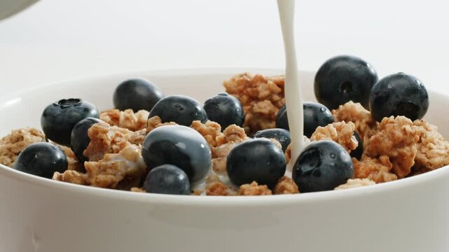 Whole grain cereals with fresh milk for breakfast, healthy breakfast with blueberry berries and yougurth kefir. Cooking morning breakfast.