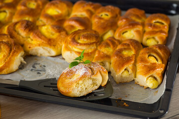 Pastries. Sweet buns with cottage cheese filling and honey in a plate on a wooden table