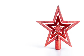Festive red Christmas star tree topper on a white background with reflection