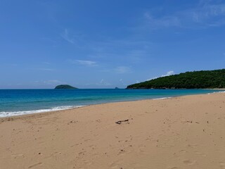 view of a deserted sandy beach in the French West Indies in Guadeloupe
