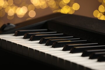 Piano against blurred lights, closeup. Bokeh effect