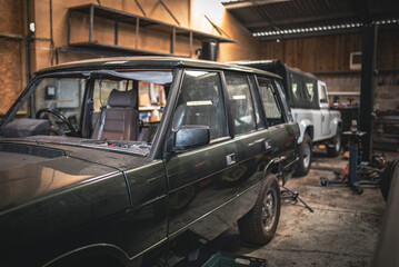 Few old classic 4x4 truck in a restoration garage being repaired and renovated © Pavel Babic