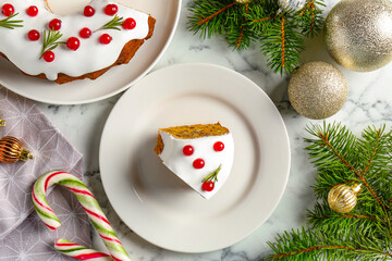 Traditional classic Christmas cake and decor on white marble table, flat lay