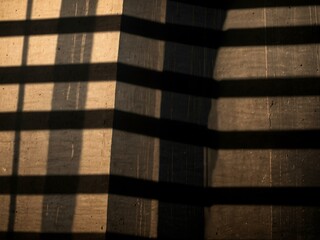 Light and shadow forming striped patterns with text space.