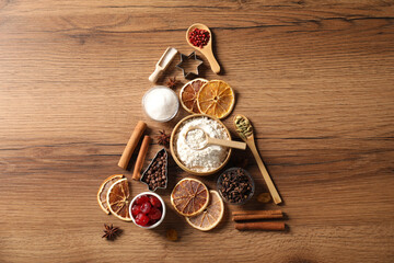 Christmas tree made with different aromatic spices on wooden table, top view