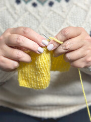 hands with knitting needles