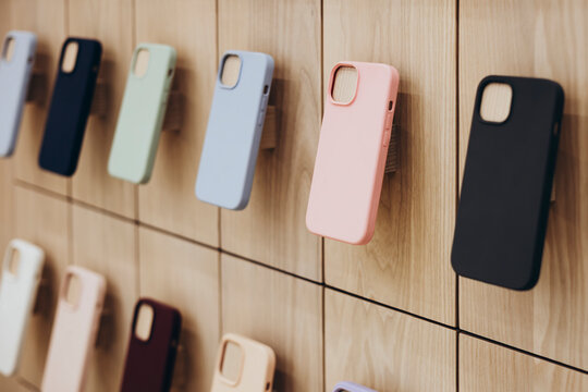 Assortment of protective cellphone phone cases in electronics shop interior.