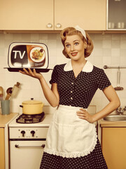 A cheerful 1950s housewife in a vintage kitchen holding a "TV Dinner," showcasing the era's convenience foods and traditional homemaking, blending retro charm and nostalgia.