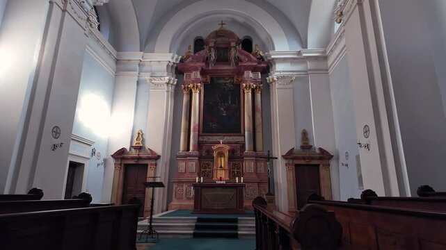Detailed footage of the ornate interior of Kloster S&auml;ben in South Tyrol, Italy. Highlights the richly decorated altar, classical architecture, wooden pews, and atmosphere of this historic monastery