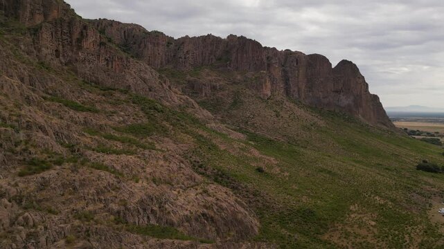 smooth drone video of Mexican Durango picteresque dessert surrounded by cliffs and rocks 
