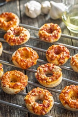 Mini pizza bagels on wooden table.