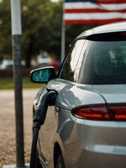 Macro shot of an ecological car charging with an American flag.