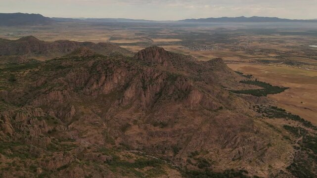 smooth drone video of Mexican Durango picteresque dessert surrounded by cliffs and rocks 