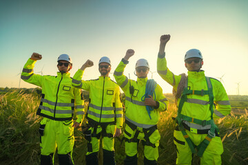 A group of  workers in high-visibility gear joyfully high-fives each other after completing their...