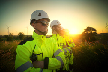 A group of  workers in high-visibility gear joyfully high-fives each other after completing their...