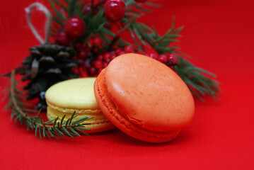 A spruce branch with a pine cone and multi-colored macaroons on a beautiful background, holiday, Christmas.