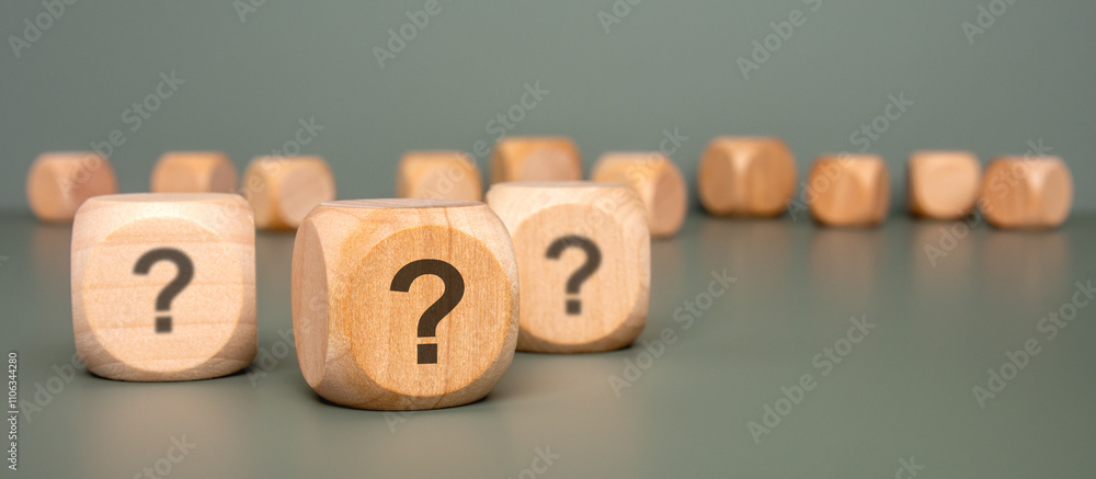 Poster intriguing wooden blocks that are beautifully displaying question marks on a gray surface