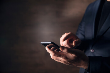 Business man hand holding smart phone