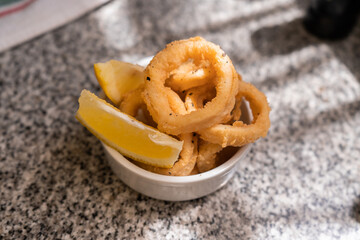 Squid rings battered and fried with a slice of lemon