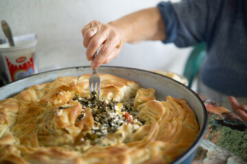 Close up of grandma's hands eating traditional homemade pie