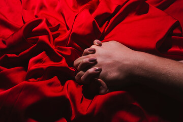 Couple sensual touch. Hands of lovers. Woman pulling sheets. Hands of love. Couple in love. Sensual hands concept. Tender couple in bed. Romance.